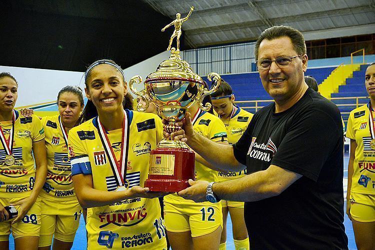 Taís, capitã do time e autora de três gols, recebendo o troféu de campeã da competição. (Foto: Alex Santos/PMSJC)