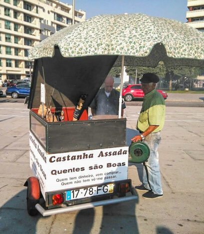 Vendedor ambulante de castanhas numa zona junto ao mar